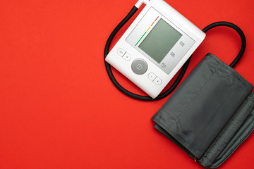 Blood pressure test. Monitor sphygmomanometer for check blood pressure isolated on red background....