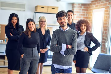 Obraz premium Group of business workers smiling happy and confident. Posing together with smile on face looking at the camera, young handsome man with crossed arms at the office