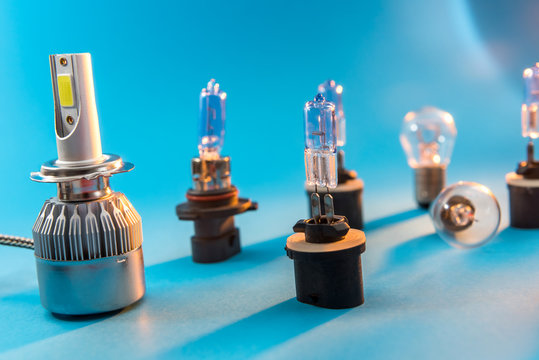 Different halogen auto bulb Isolated on blue background. Car light lamp for use in illumination when moving.