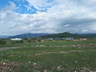 Rural landscape with clouds and green mountains