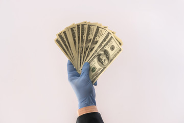 male hand give dollar to pay in protective gloves  for safety isolated on white background