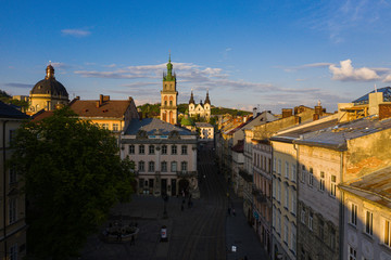 Obraz premium Aerial view on Market square, Dormition and Carmelite Church in Lviv, Ukraine from drone