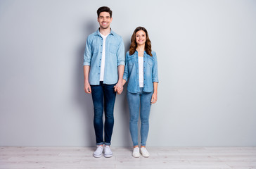 Full size photo of positive cheerful fellows spouses hold hand enjoy summer weekend walk date wear casual style clothes isolated over gray color background