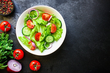 Healthy salad, leaves mix salad (mix micro greens, cucumber, tomato, onion, other ingredients). food background. copy space for text keto or paleo diet