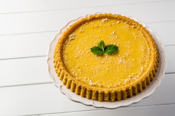 Delicious traditional homemade pie shortcrust pastry close-up on the wooden table.