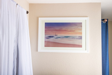 A colorful sunrise beach scene decorates a narrow beige wall. Front wide view.