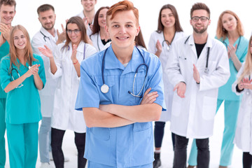 Fototapeta na wymiar confident young doctor standing in front of his colleagues