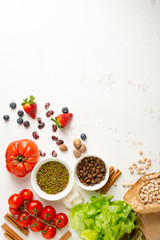 Fresh vegetarian food ingredients on white surface
