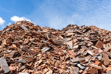 large piles of rubble and broken bricks and cinder blocks from construction sites
