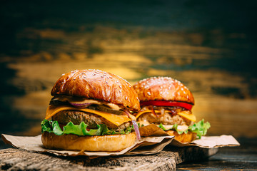two tasty beef burger on a wooden table