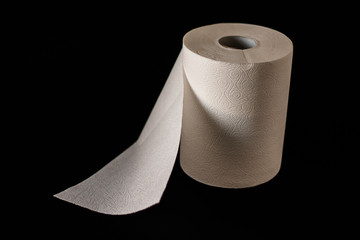 On a black background are a roll of white, kitchen and paper towels. Paper towel.
Copy space. Top view. Flat layout. Minimal background. Isolated.