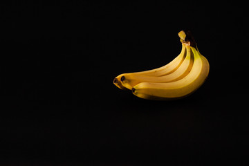 Bunch of three bananas isolated on black background. Banana fruit.
Don't be hungry. Copy space. Top view. Flat layout. Minimal background.