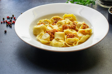 tortellini, pasta with filling (ravioli or dumplings)
second course
Menu concept. food background. top view copy space for text