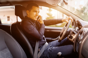 A man is sitting in a car. Vehicle interior. Businessman driving