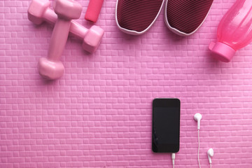 smart phone, dumbbell, shoe on exercise mat