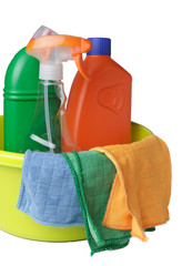 two multi-colored bottles of cleaning agent and a spray gun and multi-colored rags in a bucket for cleaning the house or office, isolate on white background