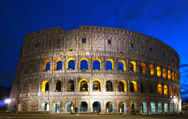 Fototapeta na wymiar Colosseum illuminated night view, Rome, Italy. Colosseo, Roma. Tourists with motion blur.