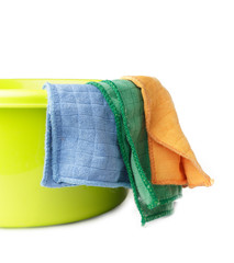 three cleaning cloths hang on a green basin for cleaning surfaces, isolate on white background