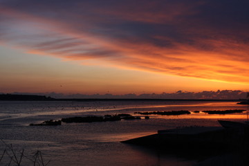 Fototapeta na wymiar Sunset at the ocean, silhouettes, natural colors