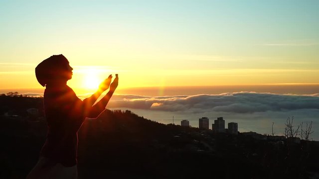 Silhouette of a Muslim woman who prays. The Religion Of Islam. Beautiful dawn, sunrise in the Holy Muslim month of Ramadan
