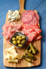 French cold cuts on plate with olives salami