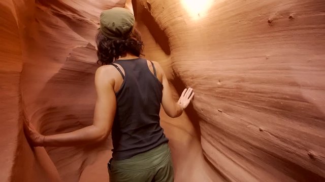 A young woman walking through Lower Antelope, Utah. United States