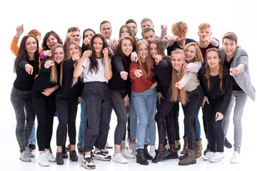team of cheerful young people pointing at you