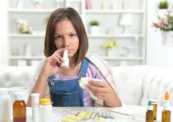 Portrait of sick little girl using inhaler