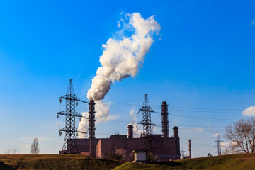 Fototapeta na wymiar View of old factory with pipes with smoke. Air pollution, environmental damage