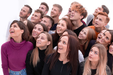 close up. happy young people looking up somewhere