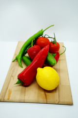 salad content top view. Fresh vegetables on wooden cutting board. salad ingredients. healthy foods. paprika, cucumber, green pepper, lemon, tomato for salad.