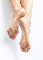 Both legs and soles of the feet on the white background