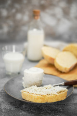 Sandwich with homemade yeast-free bread, soft cheese and milk