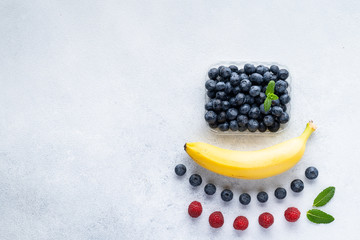 Healthy breakfast fruits and berry set on grey background. The concept of delicious and healthy food. Top view, copy space.