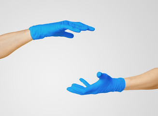 Hands in medic's nitrille blue glove.  

