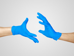 Hands in medic's nitrille blue glove.  

