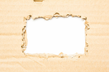 Brown torn corrugated cardboard on white background with space for text.
