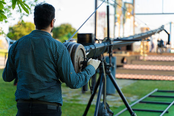 cameraman working in a broadcast television virtual outdoors tv studio.