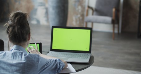 Young woman using digital tablet computer in home
