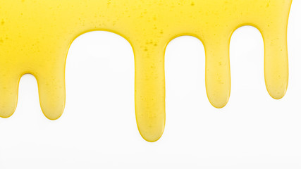 drips of honey on a white background, copy space