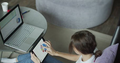 Young woman using digital tablet computer in home