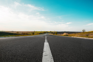 speed highway through the field. asphalt-paved road