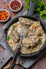 Liver stewed in sour cream with chili flakes and parsley.
