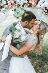 the bride and groom kiss in the forest at the wedding ceremony. selective focus. film grain.