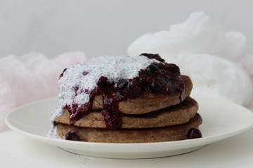 Pancakes with jam and cream on a white plate. Delicious homemade Breakfast.