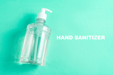 Container with alcohol gel on the light blue background