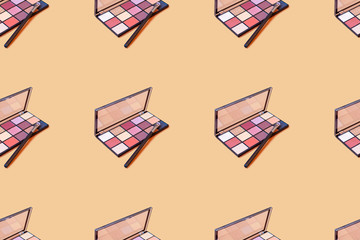 pattern from multicolor eyeshadows with brush on  beige background
