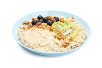 Bowl with oatmeal porridge and ingredients isolated on white background