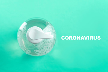 Container with alcohol gel on the light blue background