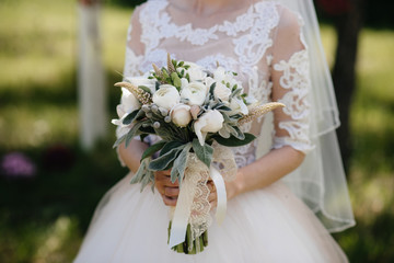 Beautiful and sophisticated wedding bouquet close-up holds the bride in her hands. Wedding bouquet